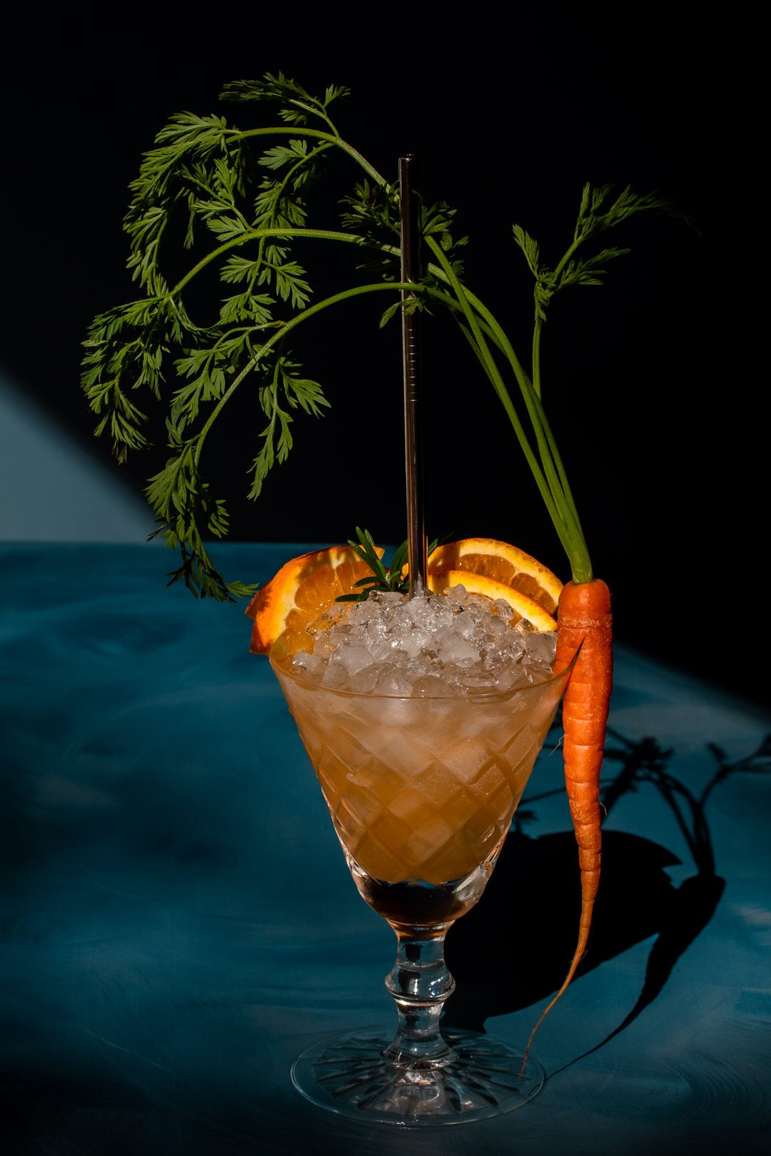 carrot shrub daisy cocktail from 45 degrees with hard light and shadows