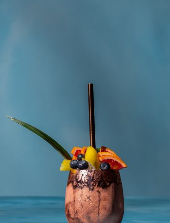 pineapple shrub gin fix cocktail on blue background