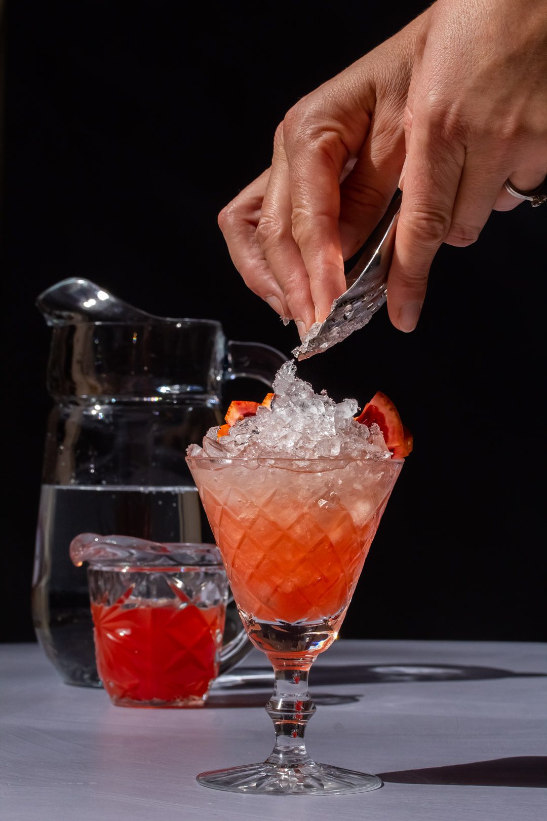 tipping ice onto improved strawberry shrub