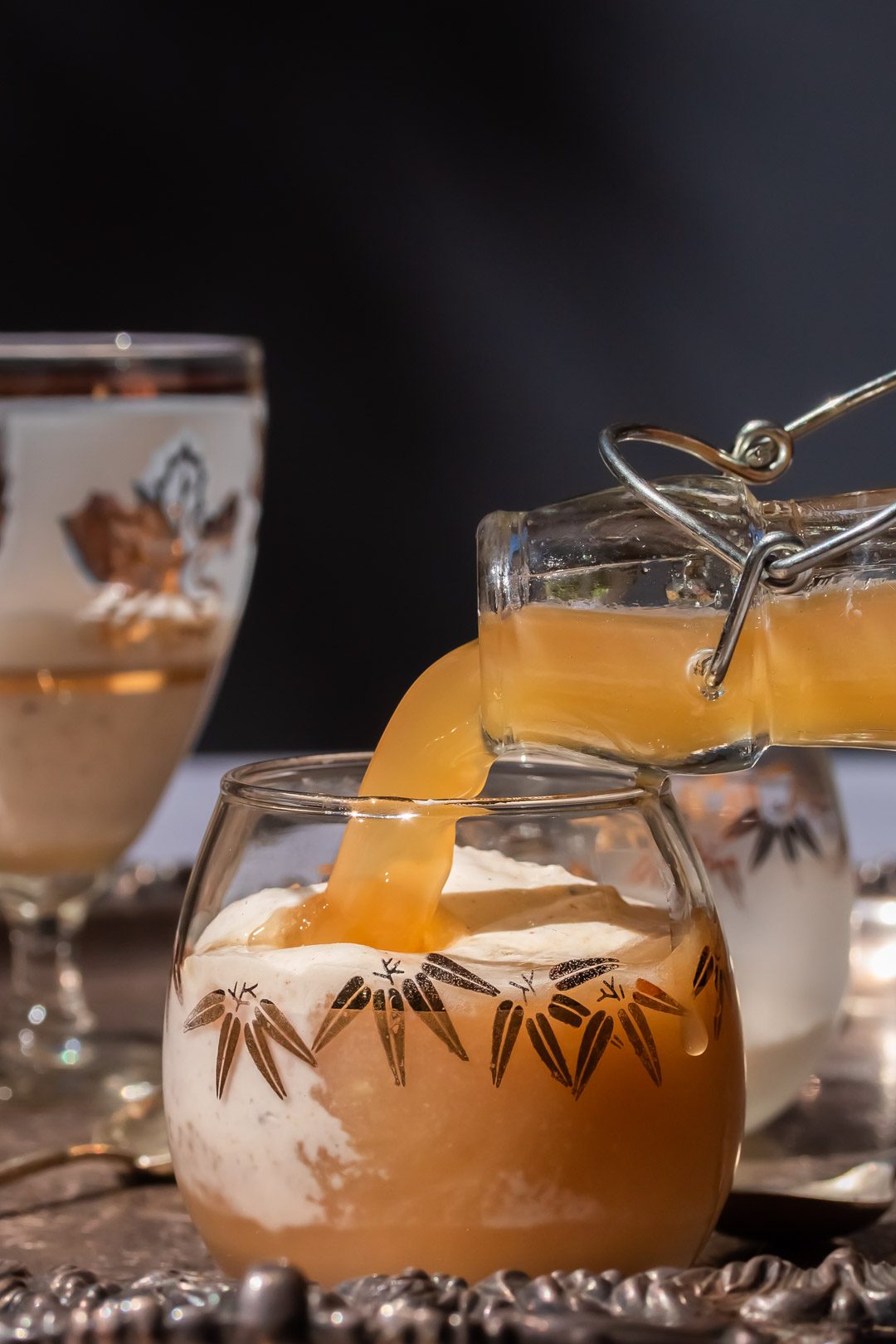 pouring ginger beer for lemon myrtle ginger beer spiders glass partially full