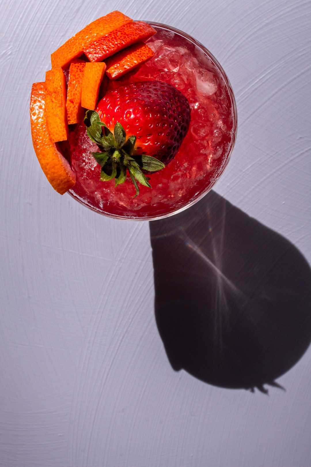 improved strawberry shrub from above on light purple background