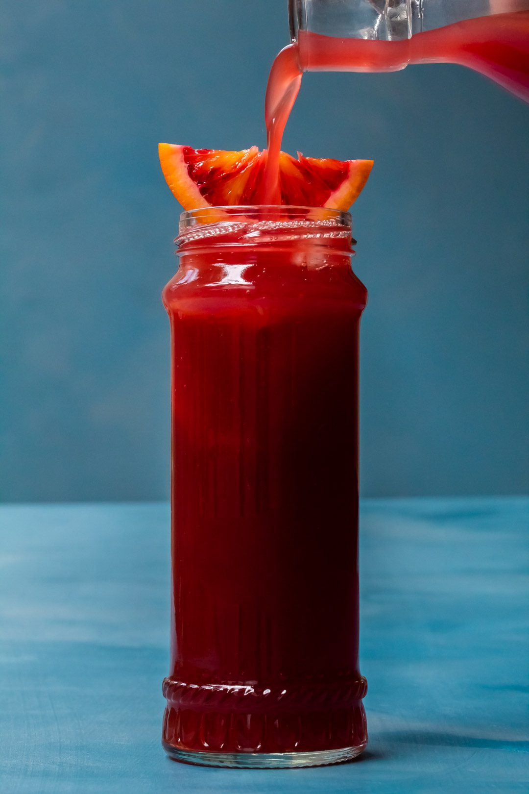 pouring blood orange soda for pickle blood orange Americano cocktail