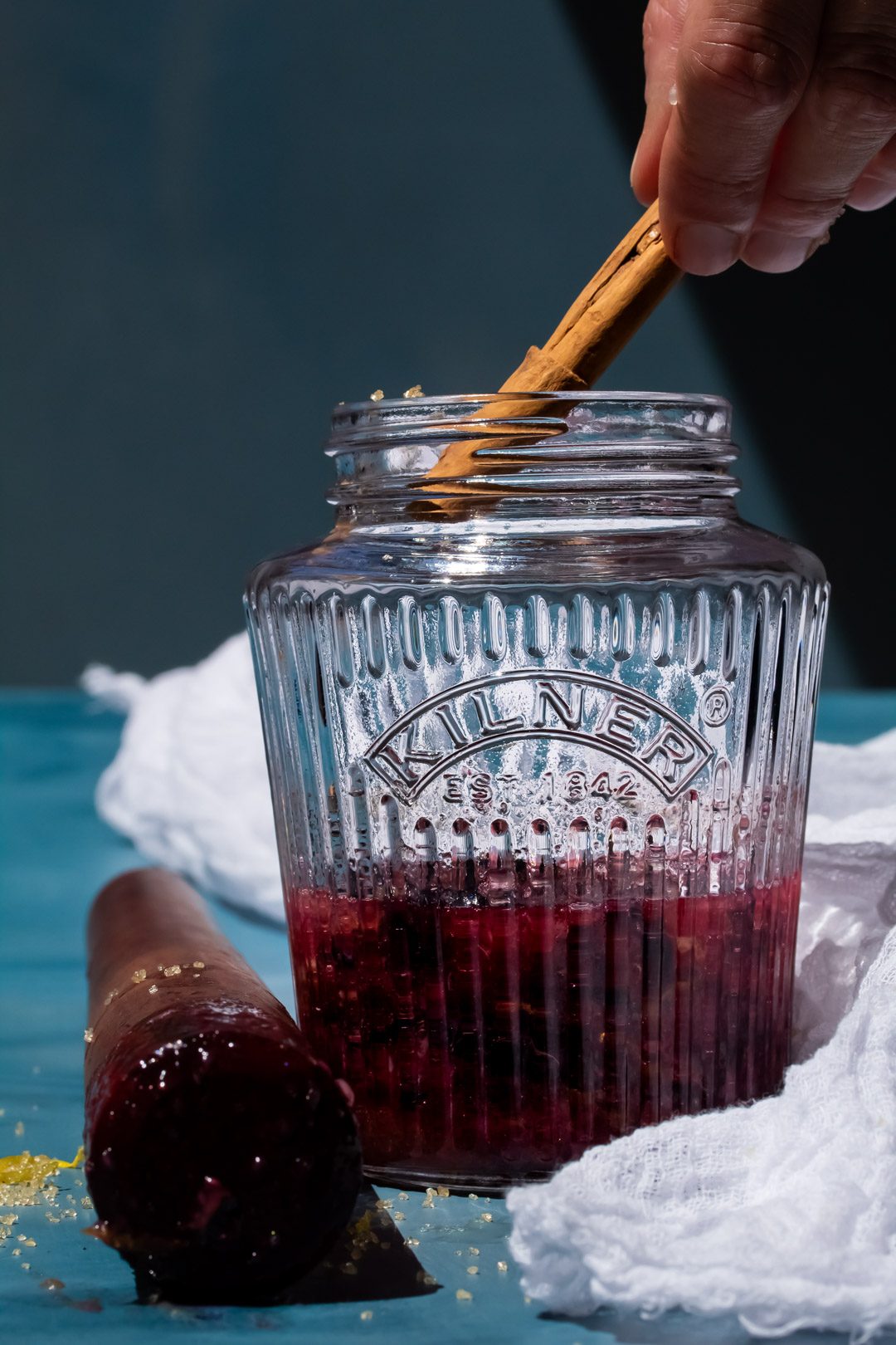 making blueberry shrub syrup, adding a cinnamon stick