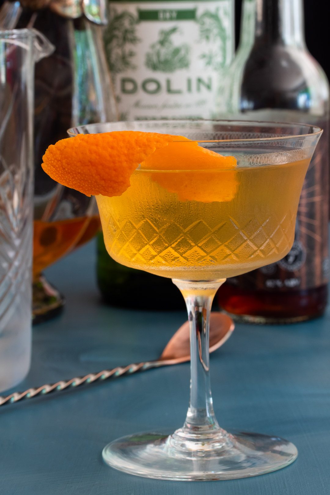 making rose lavender dry martini with bottles in background