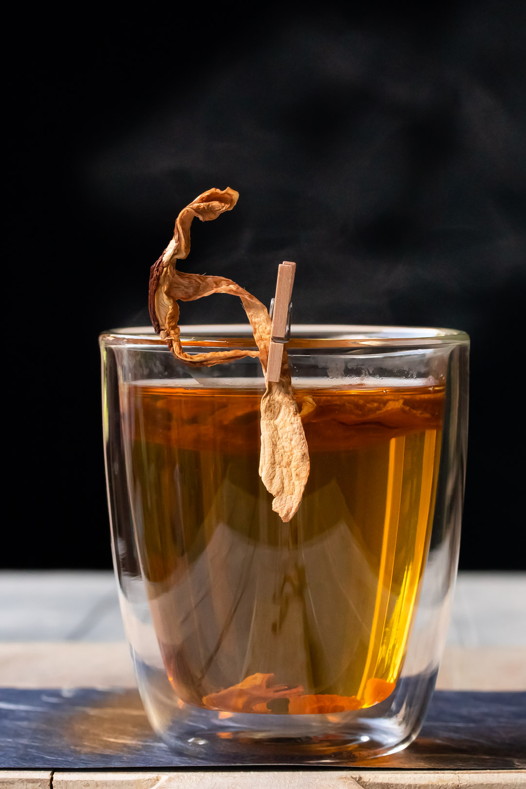 umami hot whiskey toddy with shiitake mushrooms and steam