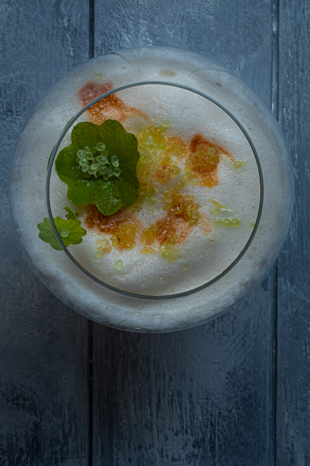 finger lime silver sour from above with finger lime caviar on nasturtium leaf