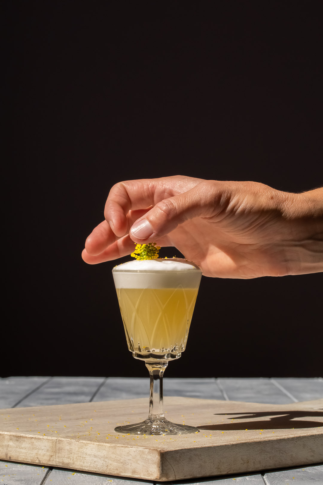 positioning fennel flower garnish on fennel flower silver sour