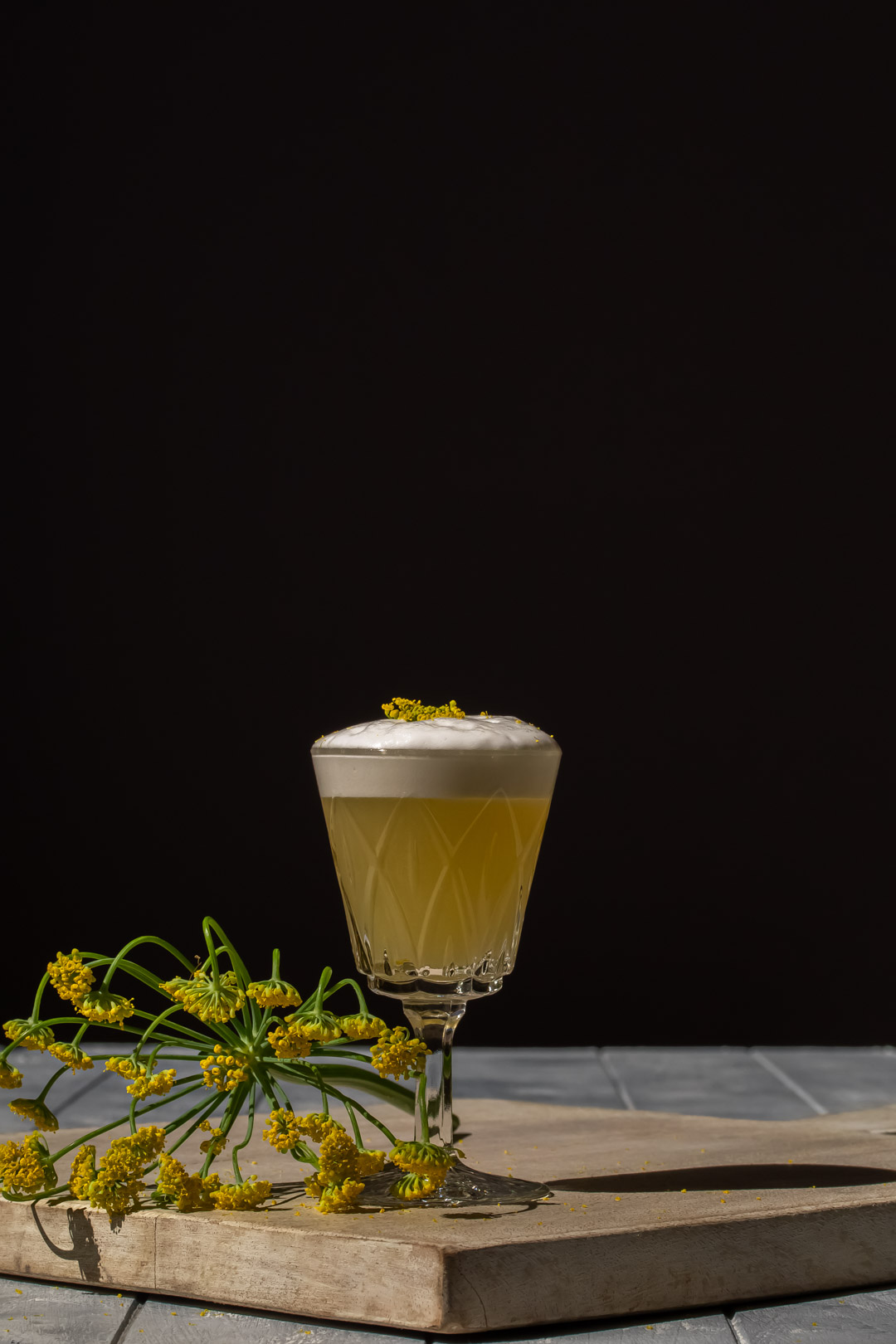 fennel flower silver sour with fennel flower garnish and fennel umbrel to left