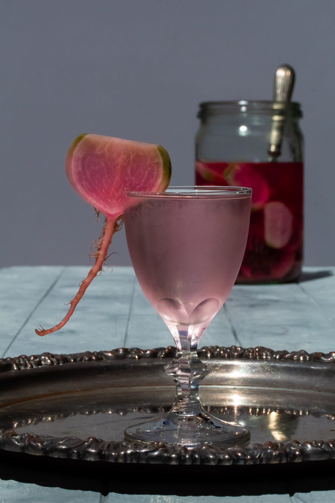 fermented watermelon radish martini with pickles far in background