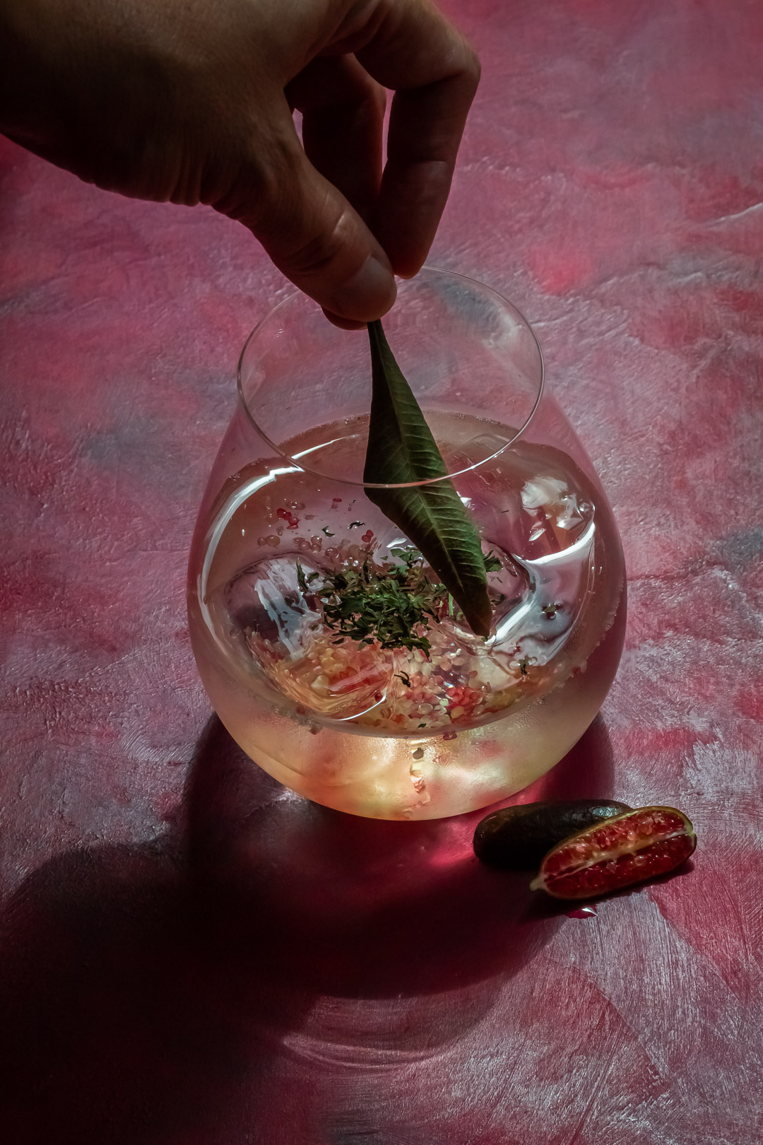 garnishing rainforest gin tonica with dried lemon myrtle leaf