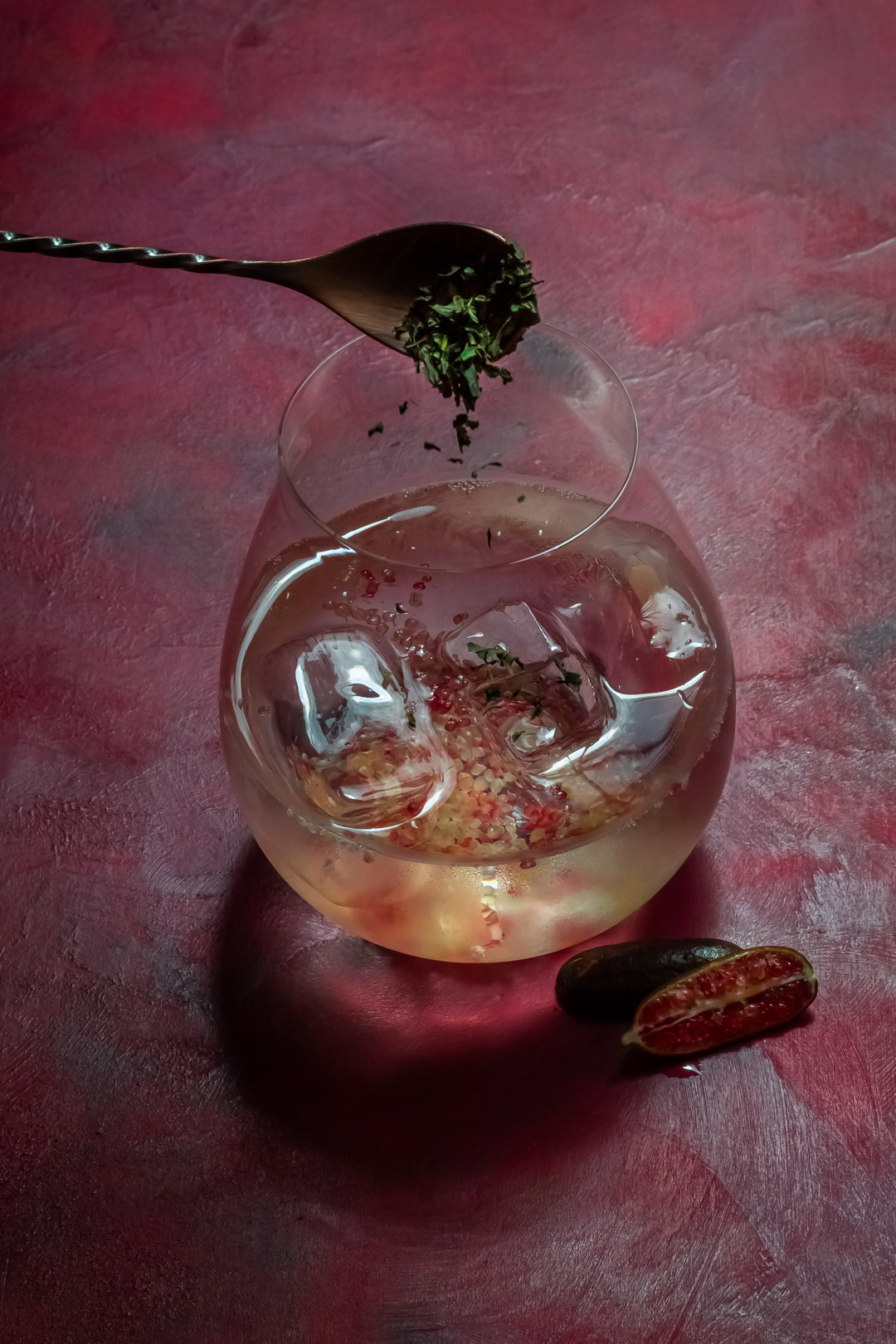 garnishing rainforest gin tonica with river mint and ants