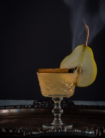 pear cinnamon sour with cinnamon smoke and pear slice