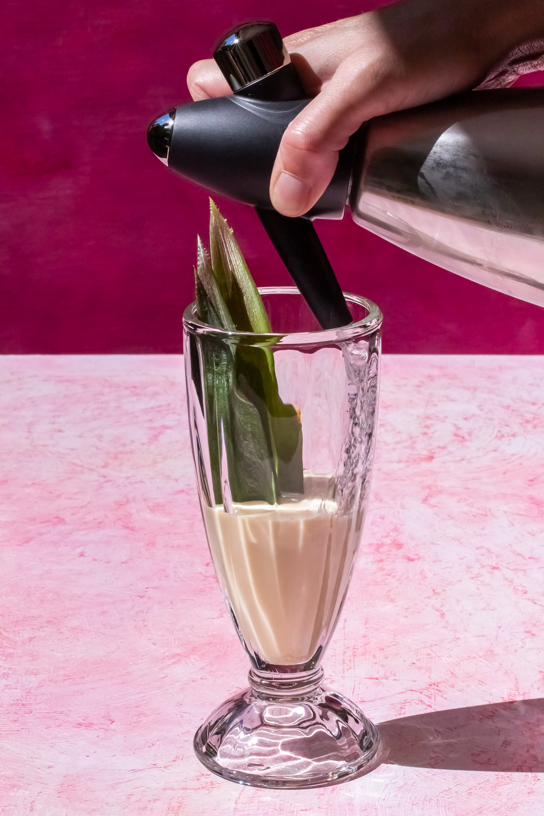 mixing syrup and cream with a fine stream of soda water for pineapple pistachio cream lactart