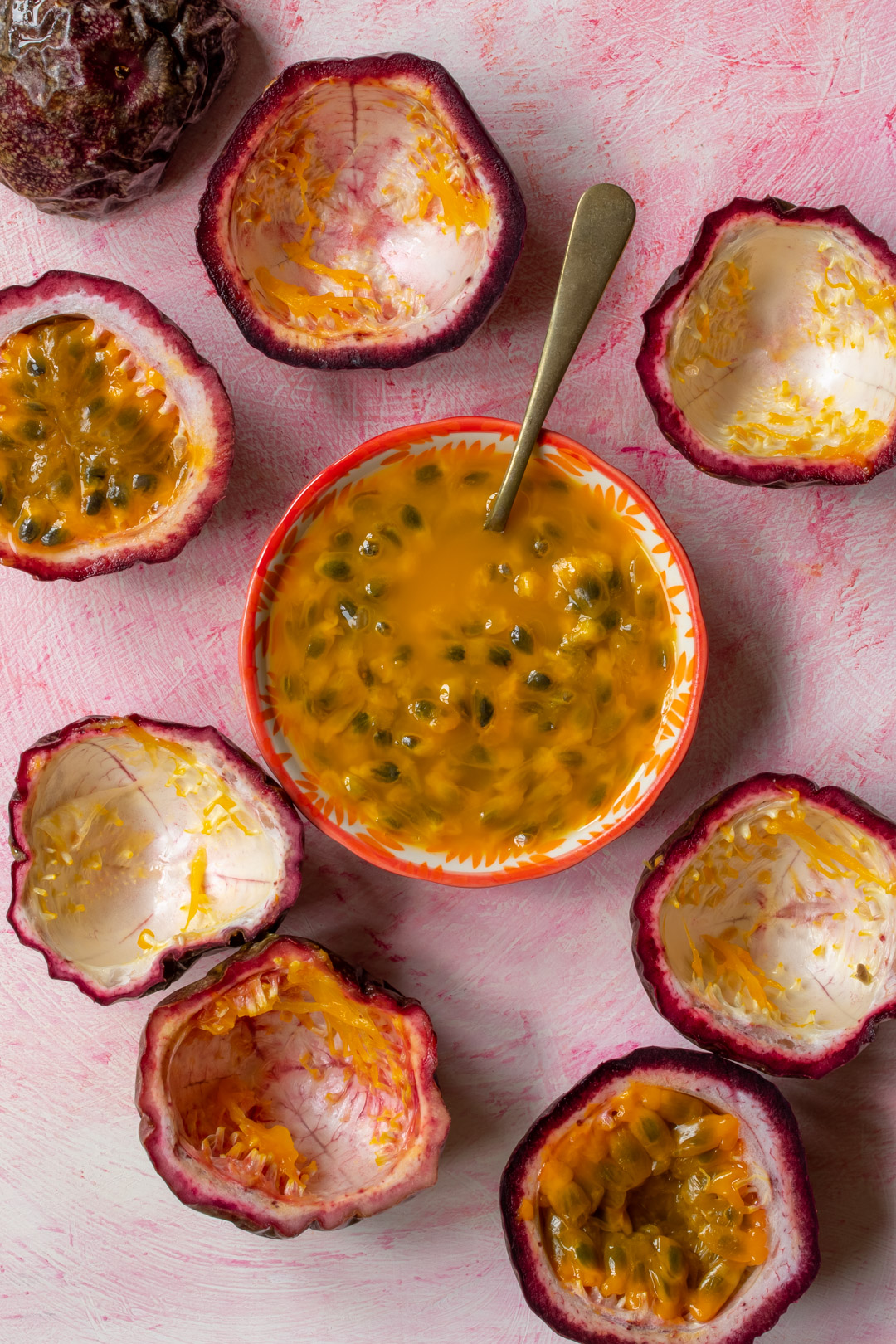 passionfruit pulp with spoon for making passionfruit syrup for passionfruit and chocolate cream lactarts