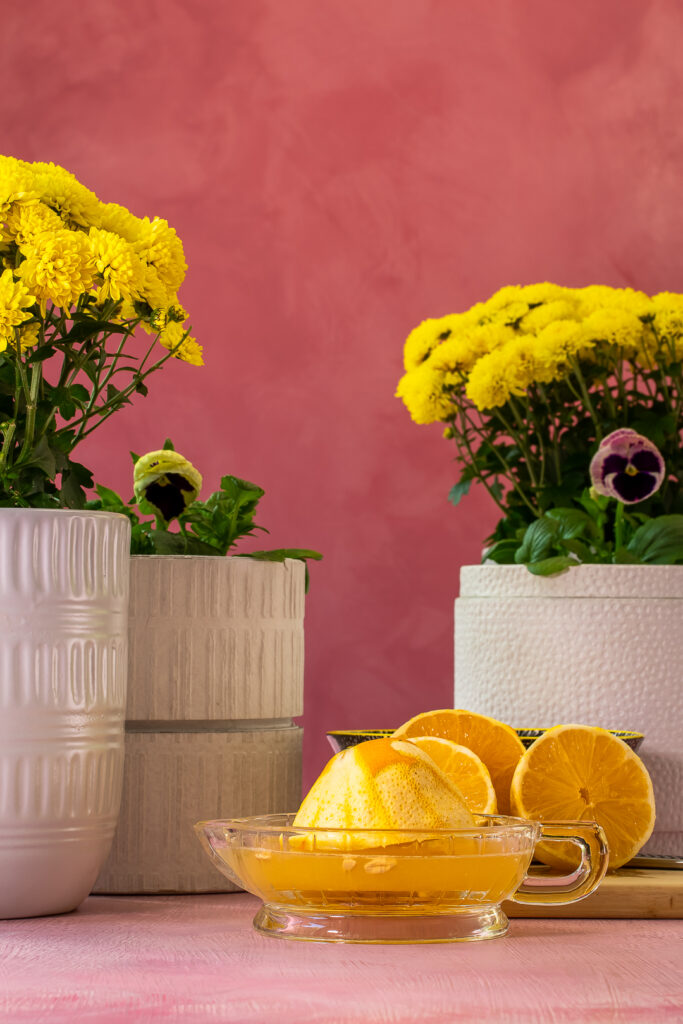 squuzing citrus for oleo saccharum shrub for fancy honey bee cocktail