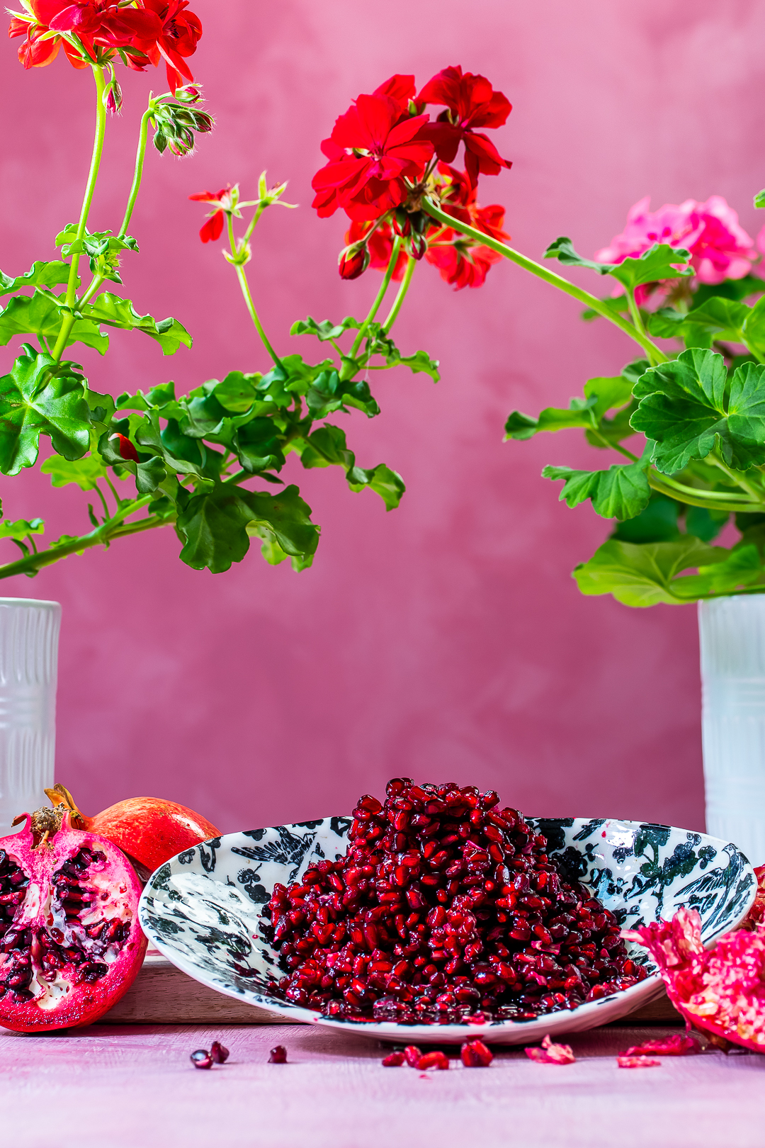 pomegranate arils with split pomegranates and shells for making grenadine