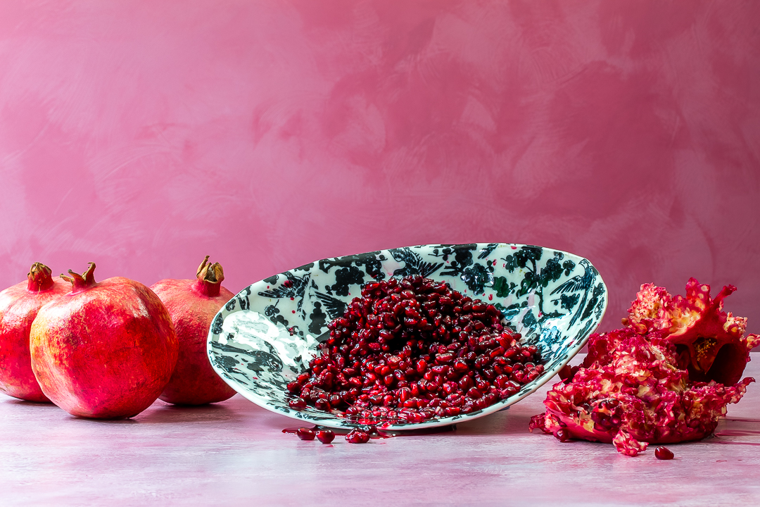 pomegranate arils with pomegranates and shells for making grenadine