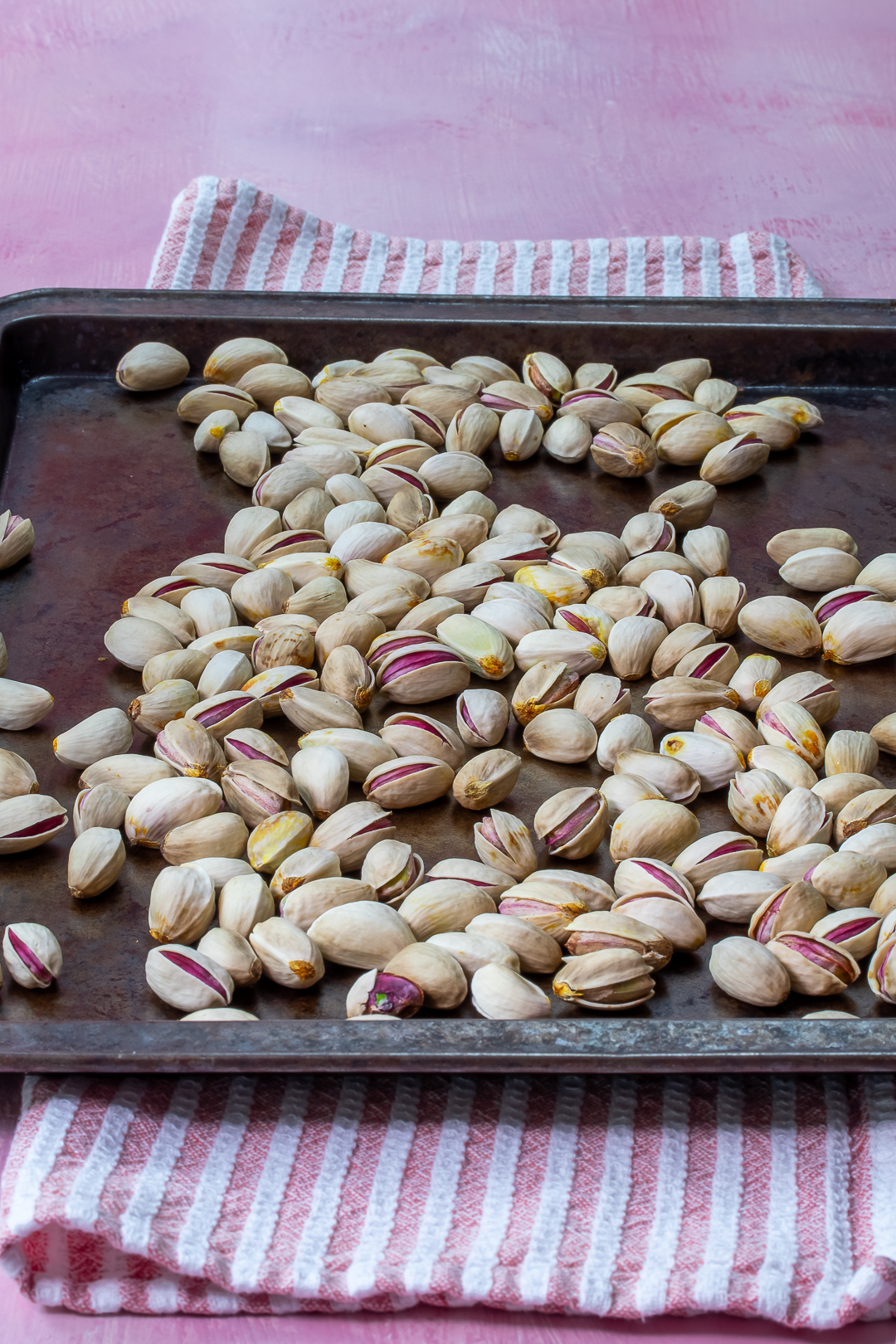 opened roasted pistachios on baking tray for making pistachio syrup for pistachio limeade