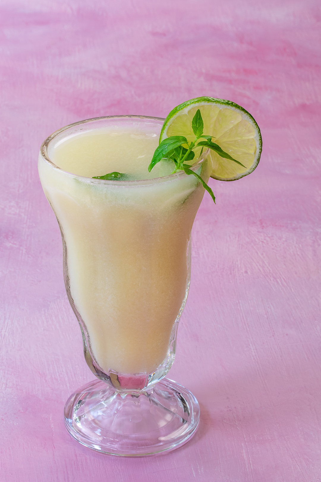 pistachio limeade from 45 degrees on a pink background