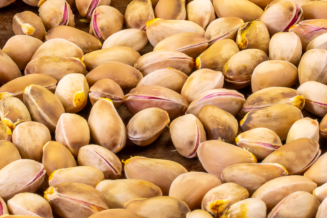 pistachios in hard shells close up for making pistachio syrup for use in pistachio limeade