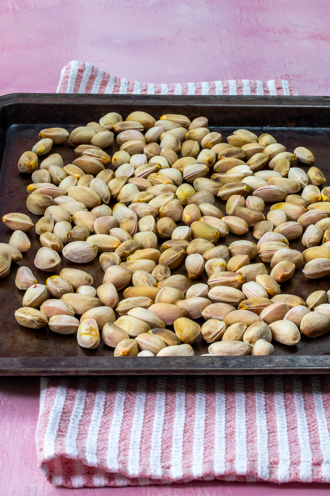shelled raw pistachios on baking tray for making pistachio syrup for pistachio limeade