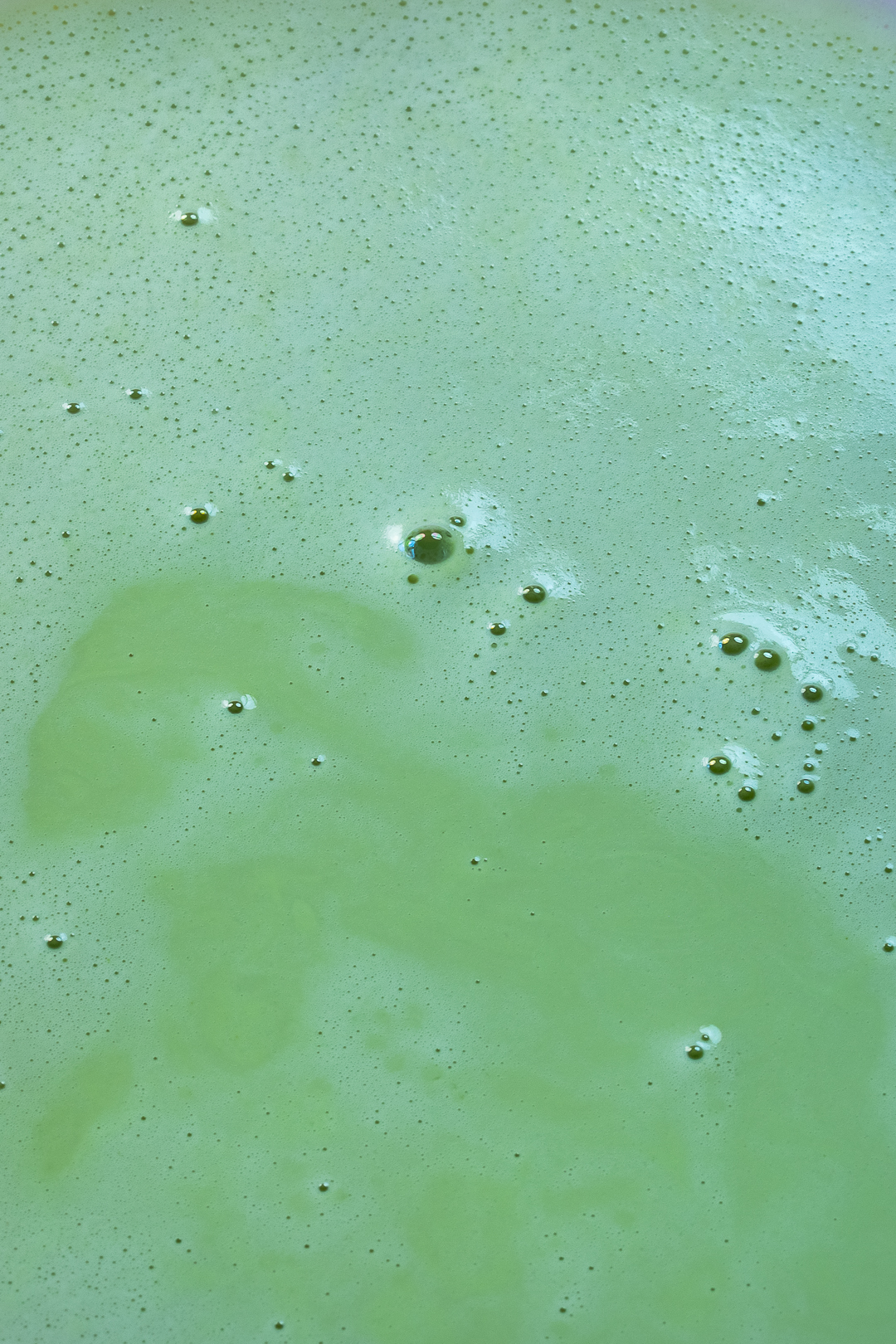 strained pistachio milk with bubbles for making psitachio syrup for pistachio limeade